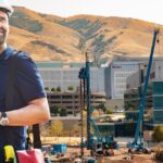A Construction Engineering Manager Smiles at his Construction Site.